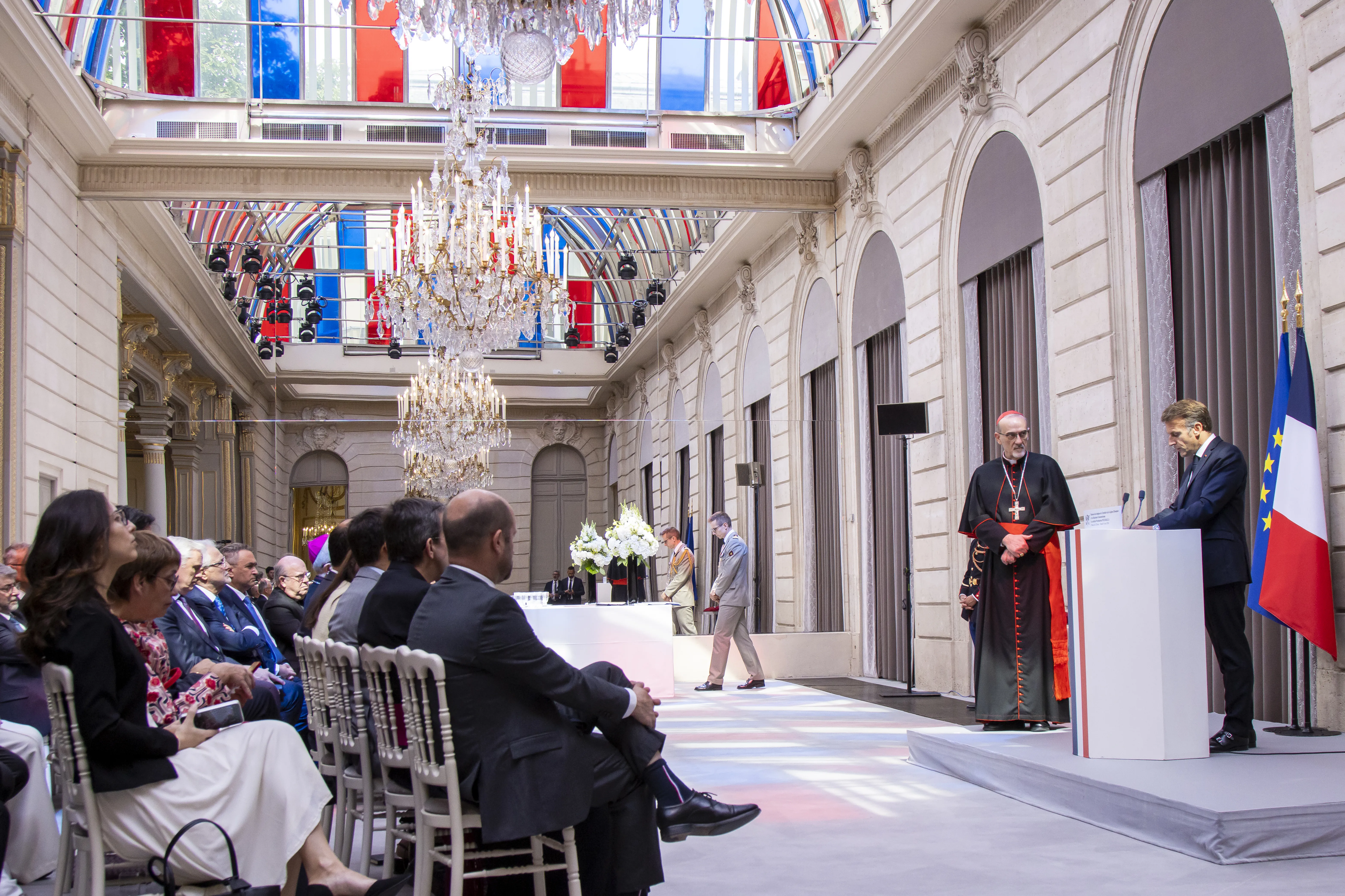 French president Emmanuel Macron addresses Cardinal Pierbattista Pizzaballa, the Latin patriarch of Jerusalem, during an official ceremony June 9, 2026, at the Élysée Palace in Paris attended by French political and Church leaders, where Macron awarded the patriarch the rank of officer in the Legion of Honor in recognition of his service to the people of the Holy Land and his ongoing efforts to promote interreligious dialogue and defend the values of justice and peace. | Credit: Sanad Sahelia/ACI MENA