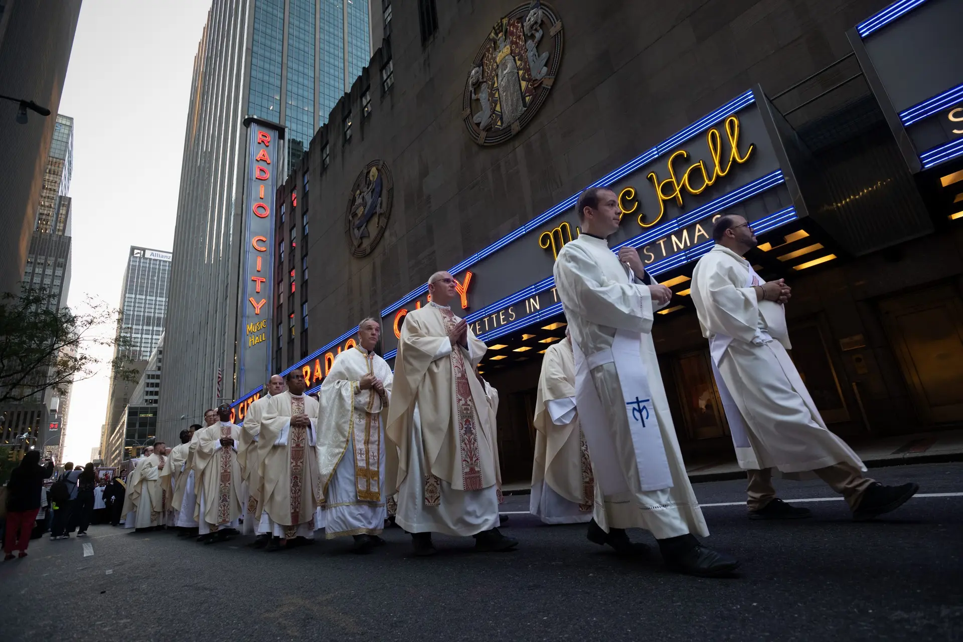 The line of priests stretches along Radio City Music Hall. | Credit: Jeffrey Bruno